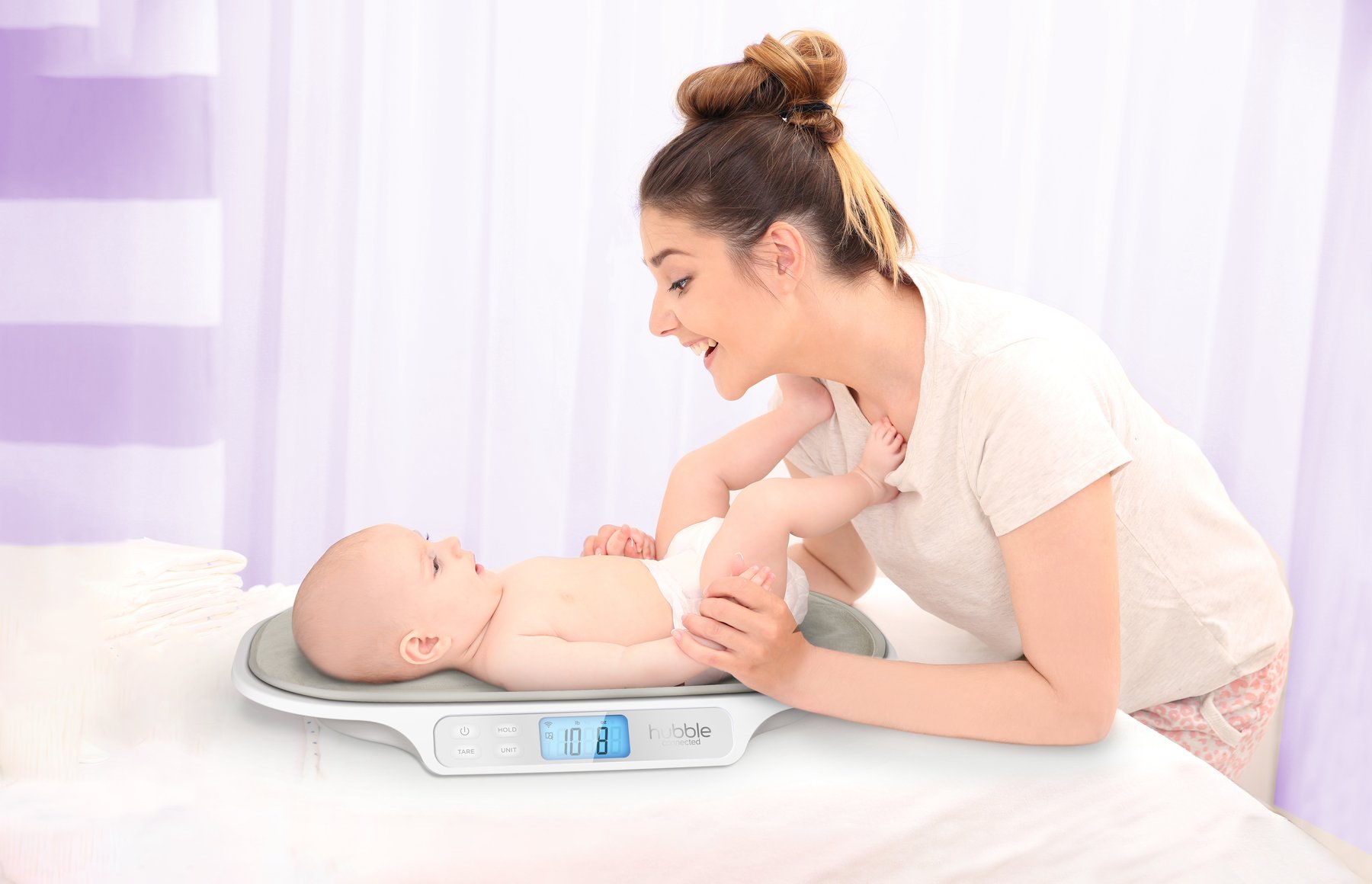 Parent using the Hubble Growth scale with a baby